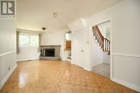 Oakville (Br Bronte) apartment for rent - A spacious living room with a fireplace and a staircase.