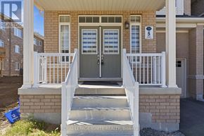 Oshawa (Taunton) apartment for rent - A house with a grey front door and white railings.