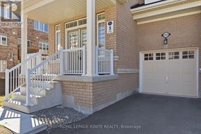 Oshawa (Taunton) apartment for rent - A house with a white garage door and a white railing on the stairs.