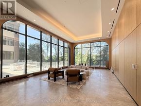 Toronto (Bayview Village) condo for rent - A room with a white wall and a wooden floor with a door on the left and a glass door on the right.