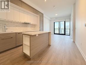 Toronto (Bayview Village) condo for rent - A bathroom with a marble floor and walls, a white bathtub, and a walk-in shower.