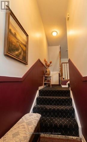 Markham (Commerce Valley) townhouse for rent - A staircase with a red wall and a painting on the wall.
