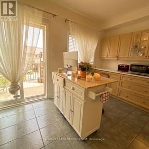 Markham (Commerce Valley) townhouse for rent - A kitchen with a large island in the middle and a sliding glass door leading to a balcony.
