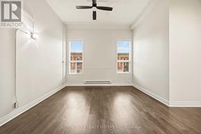 Toronto (Kensington-Chinatown) condo for rent - A room with a ceiling fan and two windows.
