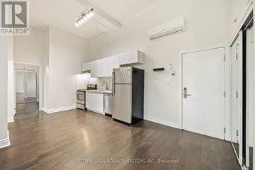 Toronto (Kensington-Chinatown) condo for rent - A kitchen area with a refrigerator, oven, and microwave.