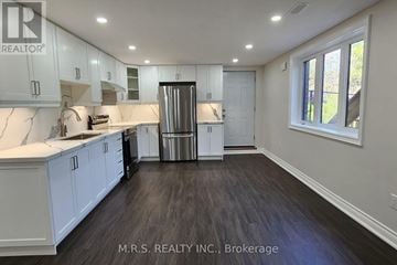 Georgina (Sutton & Jackson's Point) apartment for rent - A kitchen with white cabinets and a stainless steel refrigerator.