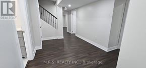 Georgina (Sutton & Jackson's Point) apartment for rent - A hallway with wood flooring and white walls.