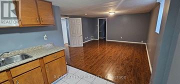 Brampton (Brampton South) apartment for rent - A kitchen with wooden cabinets and a sink.
