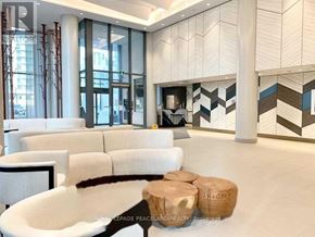 Toronto (Henry Farm) condo for rent - A modern living room with a white sofa and a coffee table.