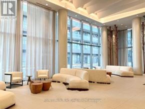 Toronto (Henry Farm) condo for rent - A spacious waiting area with white furniture and large windows.