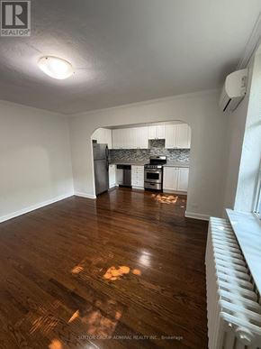 Toronto (Yonge-Eglinton) multi-family for rent - A room with wooden floors and a white radiator on the wall.
