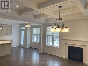 Innisfil apartment for rent - A well-lit, spacious living room with a fireplace and a chandelier.