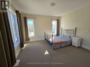 Oro-Medonte apartment for rent - A bedroom with a bed, nightstand, and window.