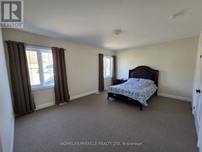 Oro-Medonte apartment for rent - A bedroom with a bed, carpeted floor, and two windows.