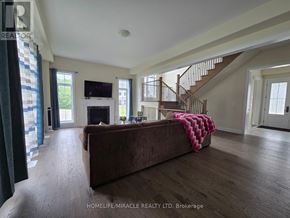 Oro-Medonte apartment for rent - A living room with a brown couch and a staircase.