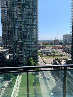 Mississauga (City Centre) condo for rent - A view from a high-rise building looking down at a cityscape with a green space in the foreground.