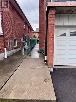 Vaughan (West Woodbridge) apartment for rent - A red brick building with a white garage door.