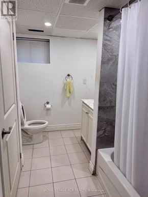 Vaughan (West Woodbridge) apartment for rent - A white bathroom with a toilet, sink, and shower curtain.