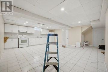 Mississauga (East Credit) apartment for rent - A room with white tiled floors and walls, a ladder, and a kitchen area with white cabinets and appliances.