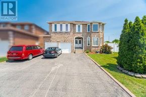 Mississauga (East Credit) apartment for rent - A large house with a driveway and two cars parked in front.