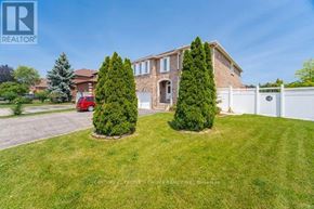 Mississauga (East Credit) apartment for rent - A house with a white fence and two trees in front.