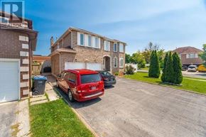Mississauga (East Credit) apartment for rent - A red car is parked in a driveway in front of a house.