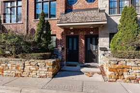 Mississauga (Applewood) townhouse for rent - A brick house with a black door and windows.