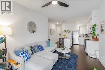 Waterloo condo for rent - A living room with a white couch and a blue rug.