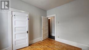 Ottawa multi-family for rent - A room with a white door and a wooden floor.