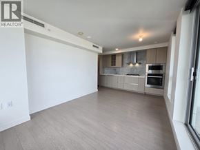 Vancouver apartment for rent - A spacious kitchen with a modern design featuring a stove top oven and a microwave.