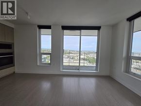 Vancouver apartment for rent - A spacious room with a view of the city through large windows.
