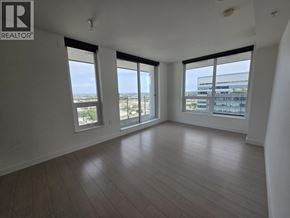 Vancouver apartment for rent - A spacious room with wooden flooring and large windows overlooking a cityscape.
