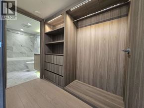 Vancouver apartment for rent - A wooden wardrobe with a glass door is in the image.