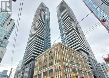 Toronto (Waterfront Communities) condo for rent - Two tall buildings are in the foreground with a third building in the background.