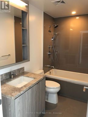 Toronto (Waterfront Communities) condo for rent - A bathroom with a sink, toilet and bathtub.