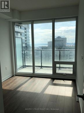 Toronto (Waterfront Communities) condo for rent - A room with a sliding glass door leading to a balcony.