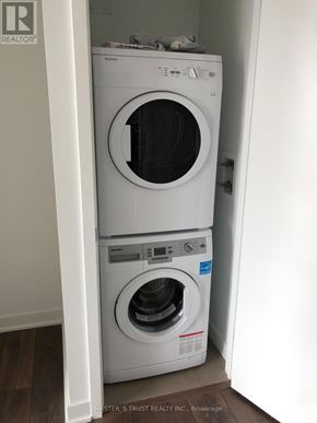 Toronto (Waterfront Communities) condo for rent - A white dryer and washer are stacked on top of each other.