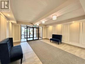 Whitchurch-Stouffville (Stouffville) condo for rent - A spacious room with a blue sofa and a carpeted floor.