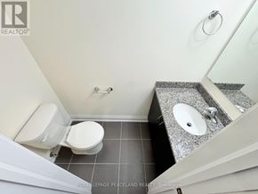 Whitchurch-Stouffville (Stouffville) condo for rent - A white toilet is in a small bathroom with a granite counter top.