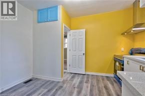 Hamilton apartment for rent - A room with a white door and a yellow wall.