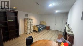 Toronto (Bayview Village) apartment for rent - A bedroom with a bed, dresser, and chair.