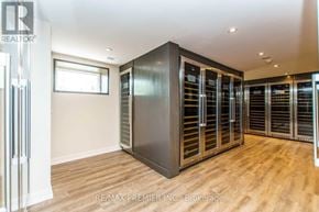 Vaughan (Kleinburg) condo for rent - A room with a large metal cabinet and wooden flooring.