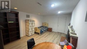 Toronto (Bayview Village) apartment for rent - A bedroom with a bed, dresser, and chair.