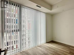 Toronto (Waterfront Communities) condo for rent - A room with a sliding door and a wooden floor.