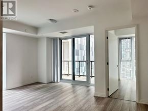 Toronto (Waterfront Communities) condo for rent - A room with a sliding glass door leading to a balcony.