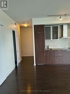 Toronto (Waterfront Communities) condo for rent - A dining room with a table set for four and a white wall.