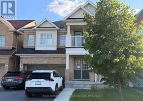 Brampton (Credit Valley) apartment for rent - A white car is parked in front of a house with a tree to the right.