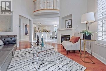 Vaughan (Maple) apartment for rent - A living room with a grey couch and a glass coffee table.