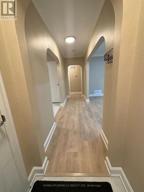 Vaughan (Vaughan Grove) apartment for rent - A hallway with a black doormat that says "HOMELIFE/MIRACLE REALTY LTD. Brokerage".