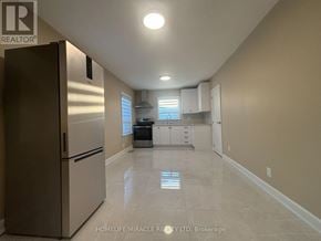 Vaughan (Vaughan Grove) apartment for rent - A kitchen with a refrigerator, sink, and cabinets.